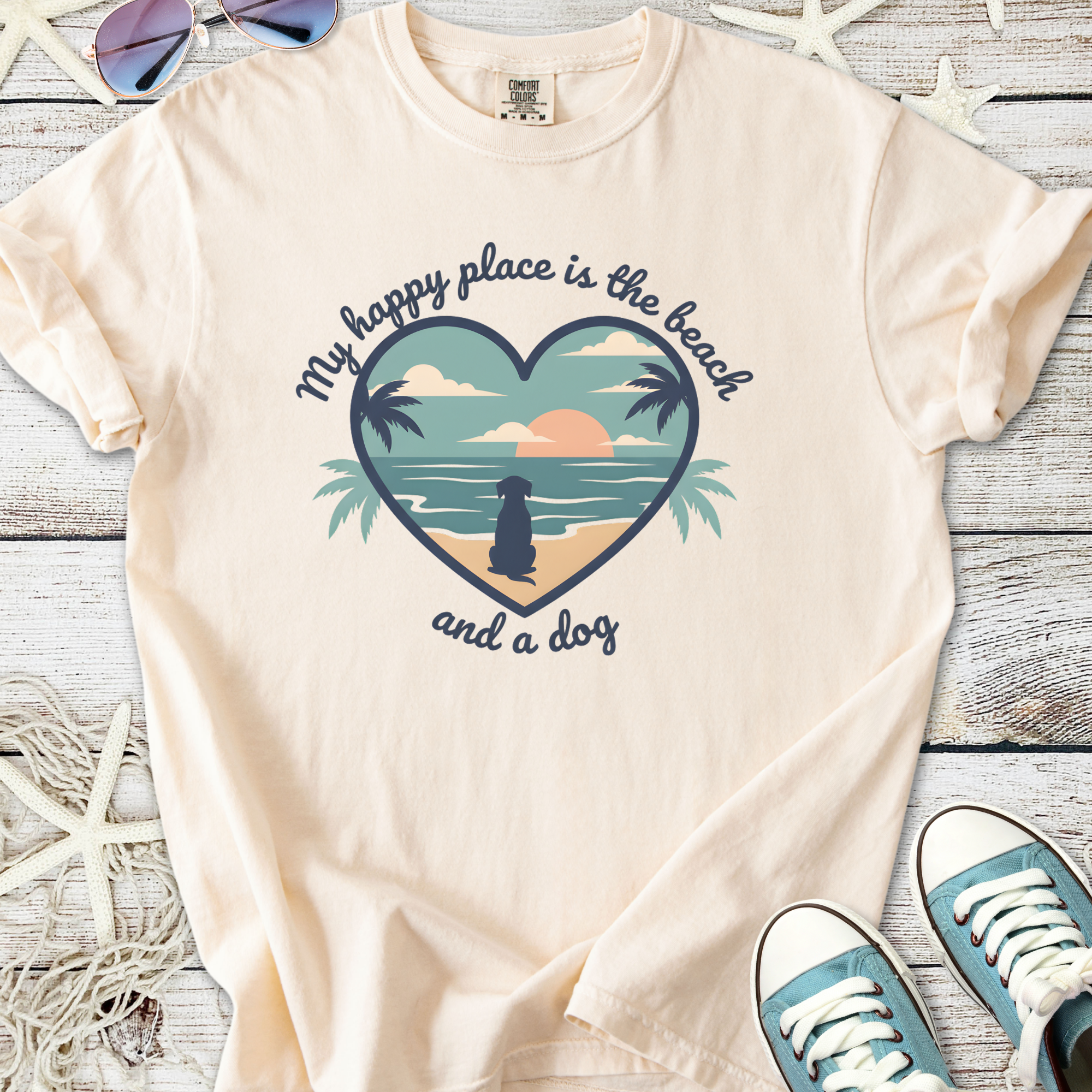 Cream cotton t-shirt with beach-themed graphic saying 'My happy place is the beach and a dog'.