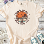 Beige cotton t-shirt with 'Salt in the Air, Peace in My Soul' graphic and beach sunset design.