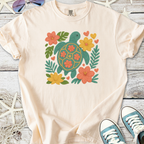 Cream cotton t-shirt with an embroidered turtle and floral design, perfect for casual summer wear.
