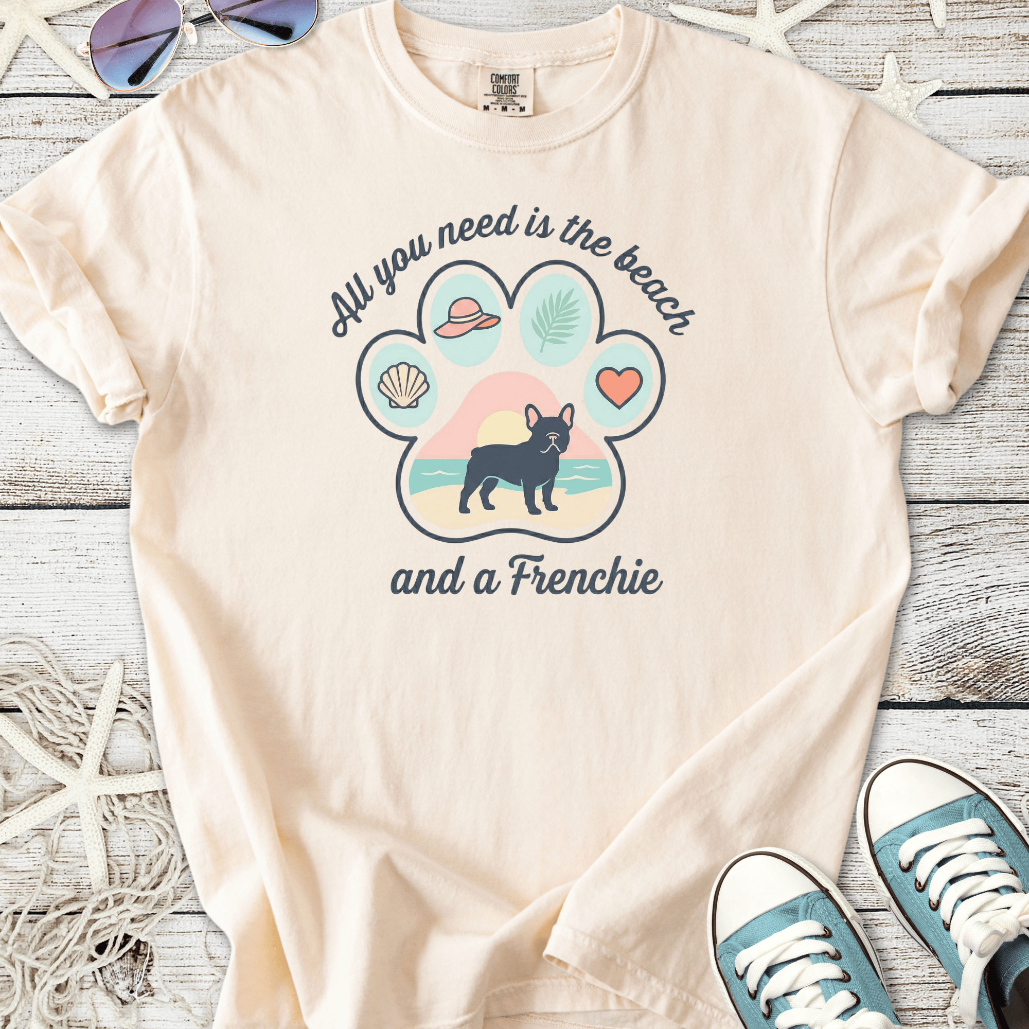 Cream graphic tee featuring a French Bulldog and beach-themed design, perfect for dog lovers.