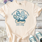 Beige graphic t-shirt featuring ocean-themed dog design and quote, perfect for beach lovers and pet owners.