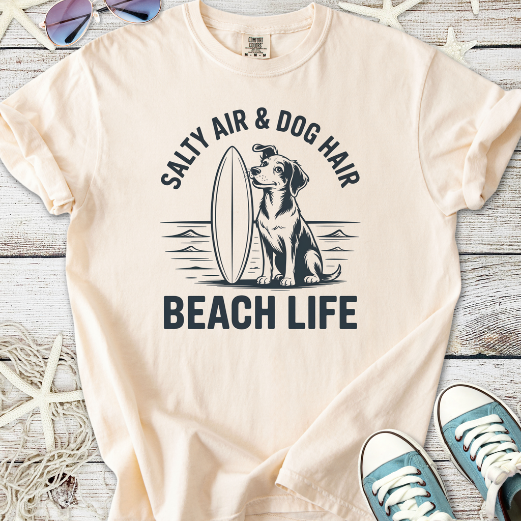 Cream t-shirt featuring dog graphic with 'Salty Air & Dog Hair Beach Life' text, perfect for beach lovers.