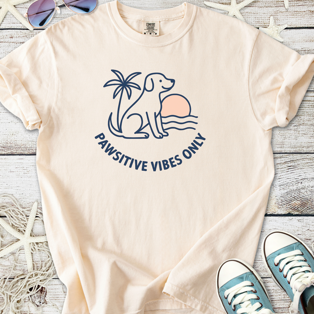 Light peach t-shirt featuring a dog, sunset, and 'Pawsitive Vibes Only' design, perfect for dog lovers.