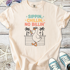 Beige graphic t-shirt featuring a fun duck design with 'Sippin, Chilllin, No Billin' text.