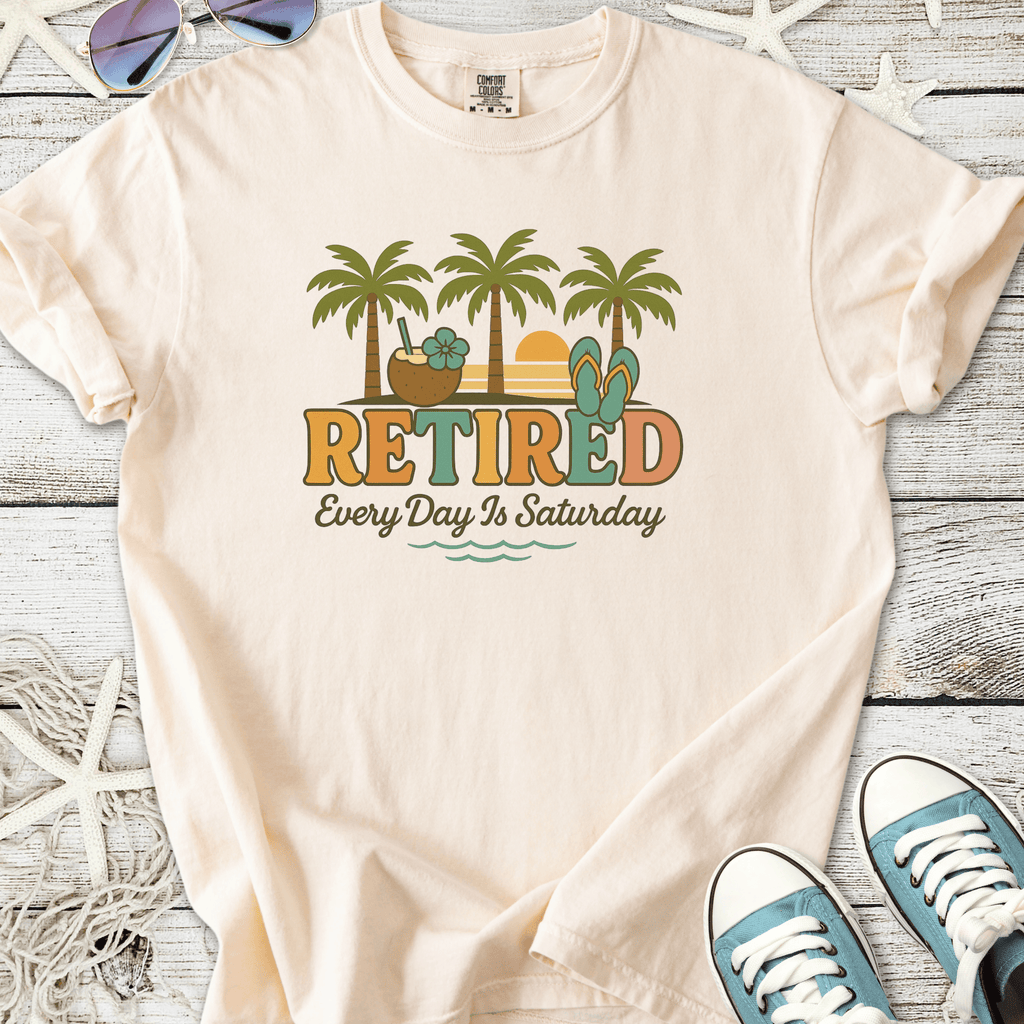 Light peach retired graphic tee with palm trees, flip flops, and beach elements for relaxed summer vibes.