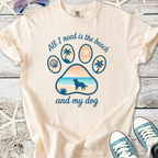 Cream beach-themed t-shirt featuring a paw print design, with the quote about dogs and the beach.