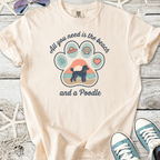 Beige graphic t-shirt featuring a poodle and beach-themed design, perfect for dog lovers.