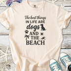 Light beige t-shirt featuring 'The best things in life are dogs and the beach' graphic design.