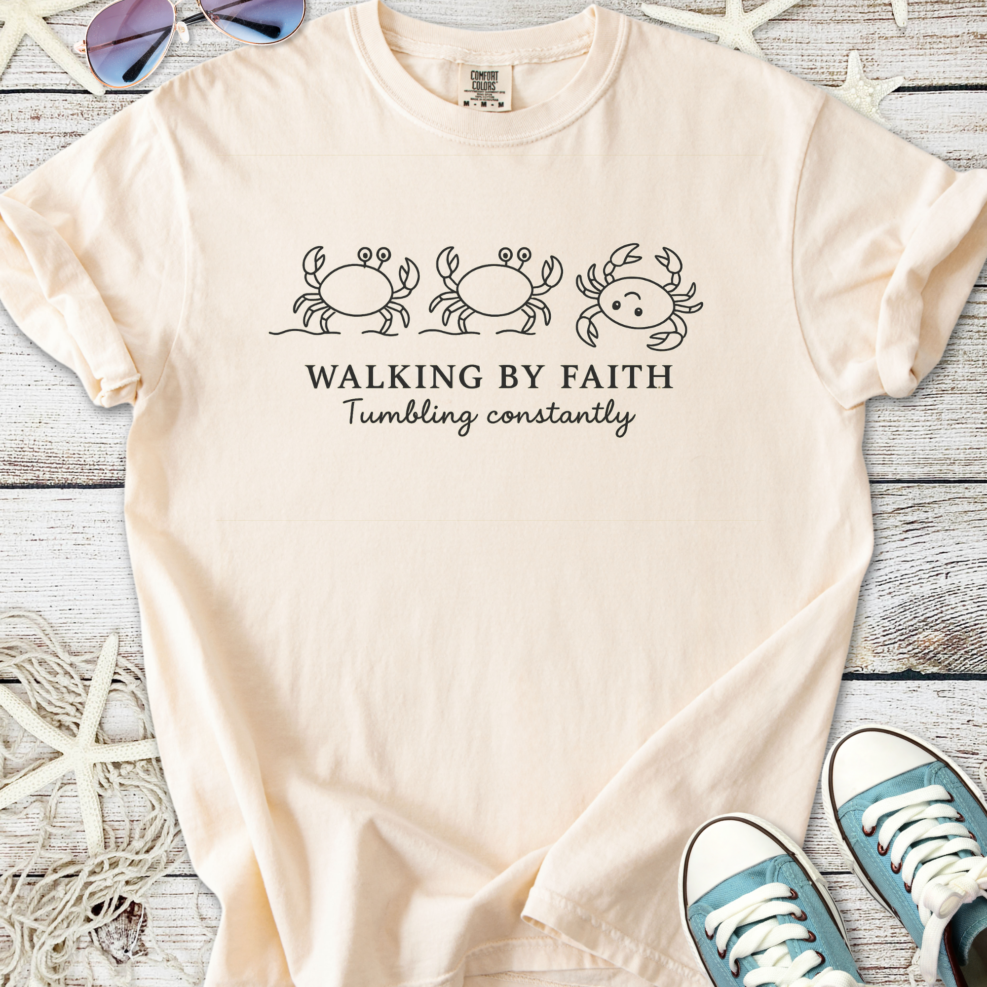 Peach graphic tee featuring crabs and the quote 'Walking by Faith', soft cotton material.