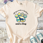 Cream graphic tee featuring a playful dog paw print and the phrase, 'All you need is Sunshine and a Dog'.