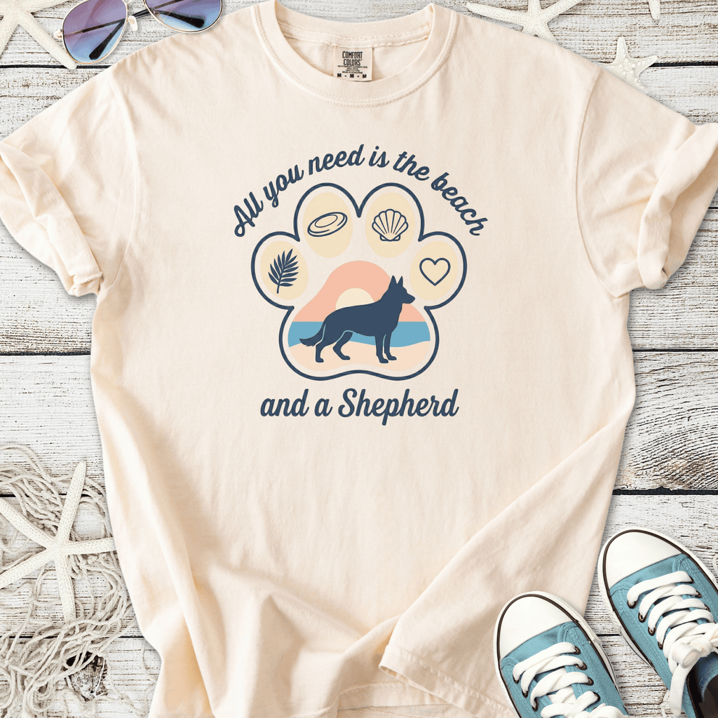 Light beige t-shirt with 'All you need is the beach and a Shepherd' graphic design. Made from soft cotton.