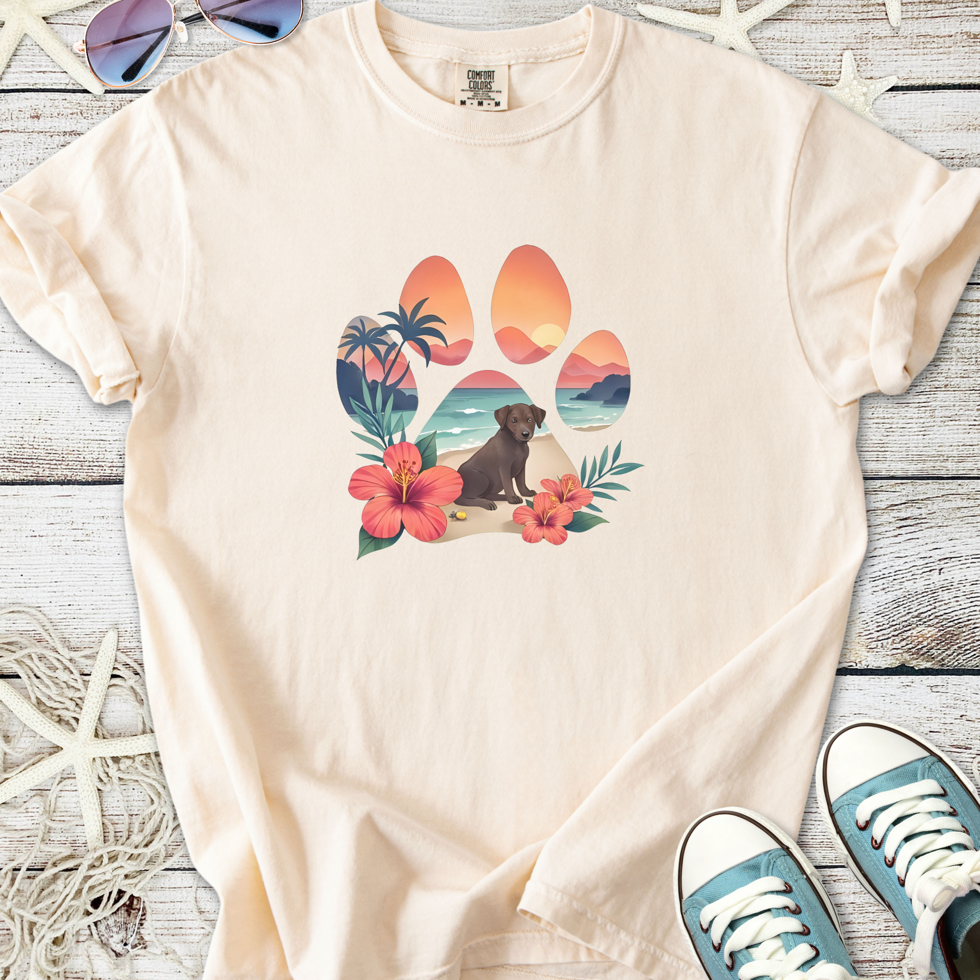 Beige t-shirt featuring a tropical paw print design with a dog and flowers.