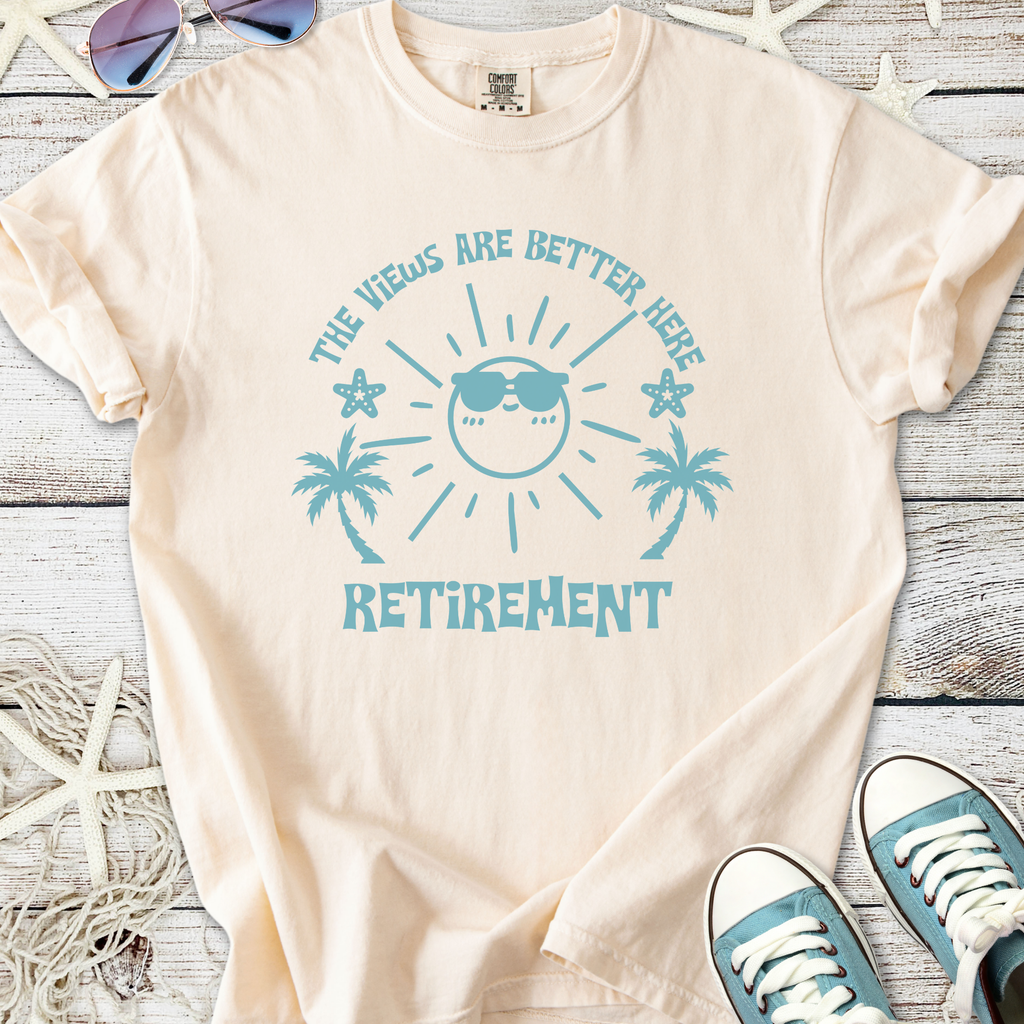 Cream retirement t-shirt with fun beach-themed graphic and text: 'The views are better here'