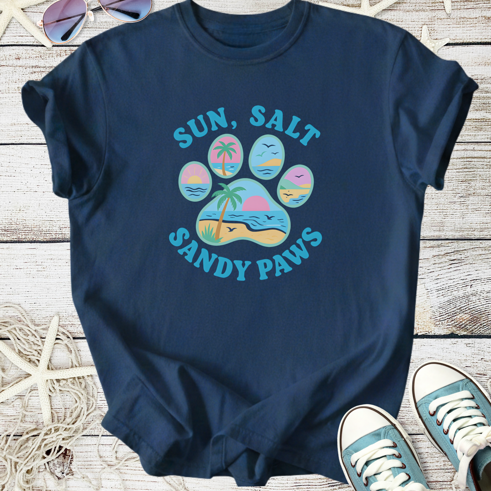 Navy blue T-shirt featuring 'Sun, Salt, Sandy Paws' graphic with beach and palm tree design.
