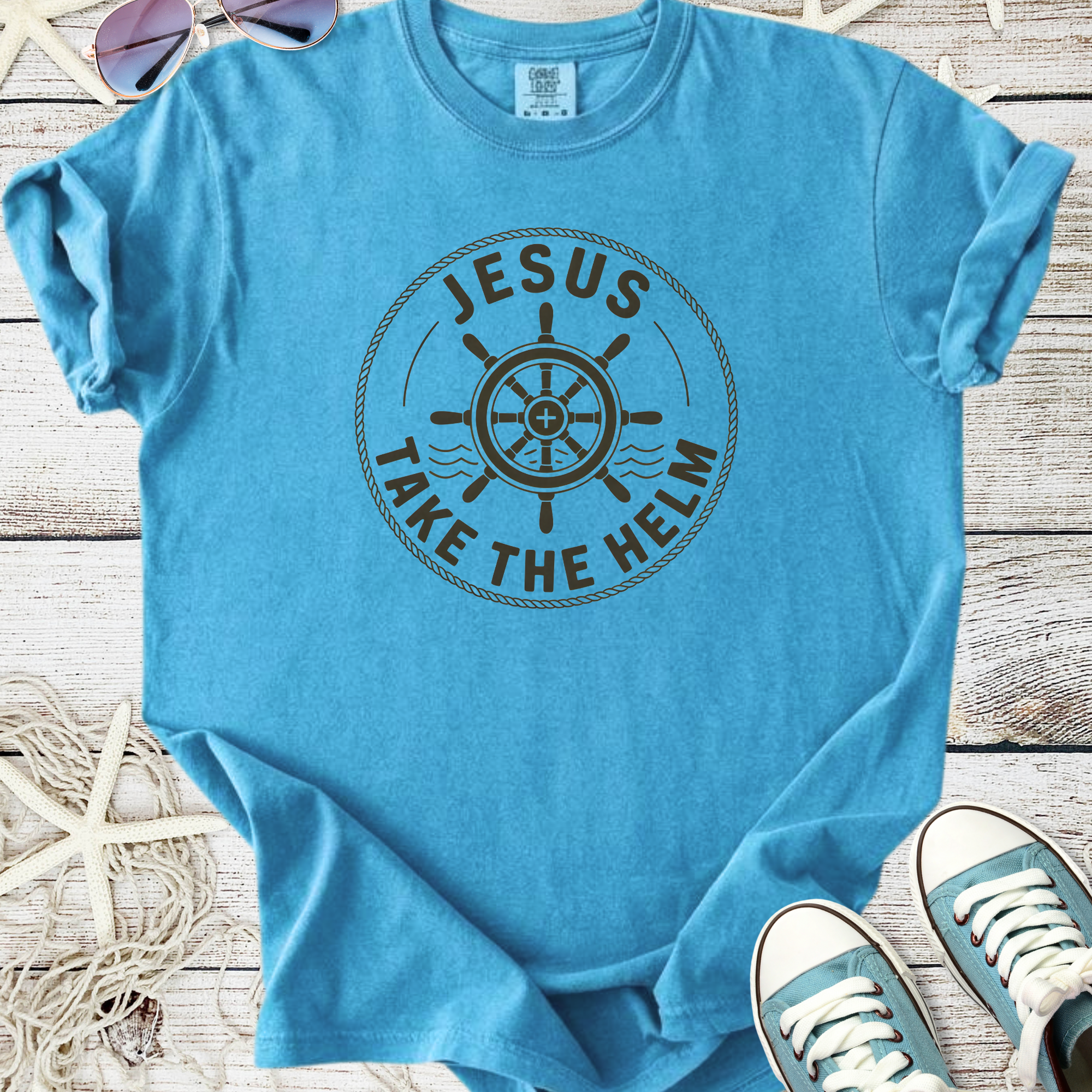 Light blue unisex t-shirt with 'Jesus Take the Helm' graphic design, perfect for casual wear.