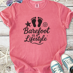 Pink cotton t-shirt with 'Barefoot is a Lifestyle' graphic design, perfect for casual summer wear.