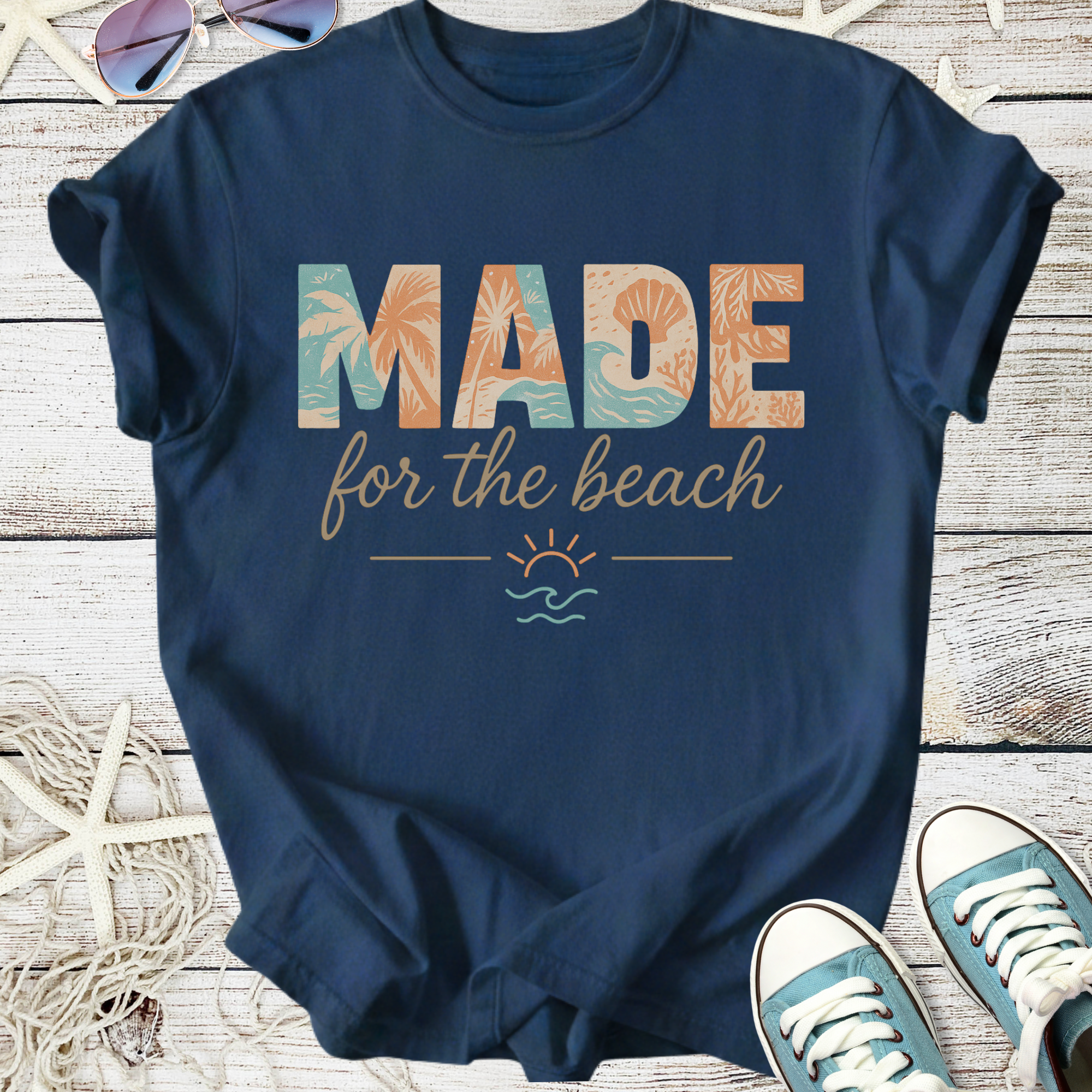 Navy blue t-shirt with 'MADE for the beach' graphic, perfect for summer outings and casual wear.