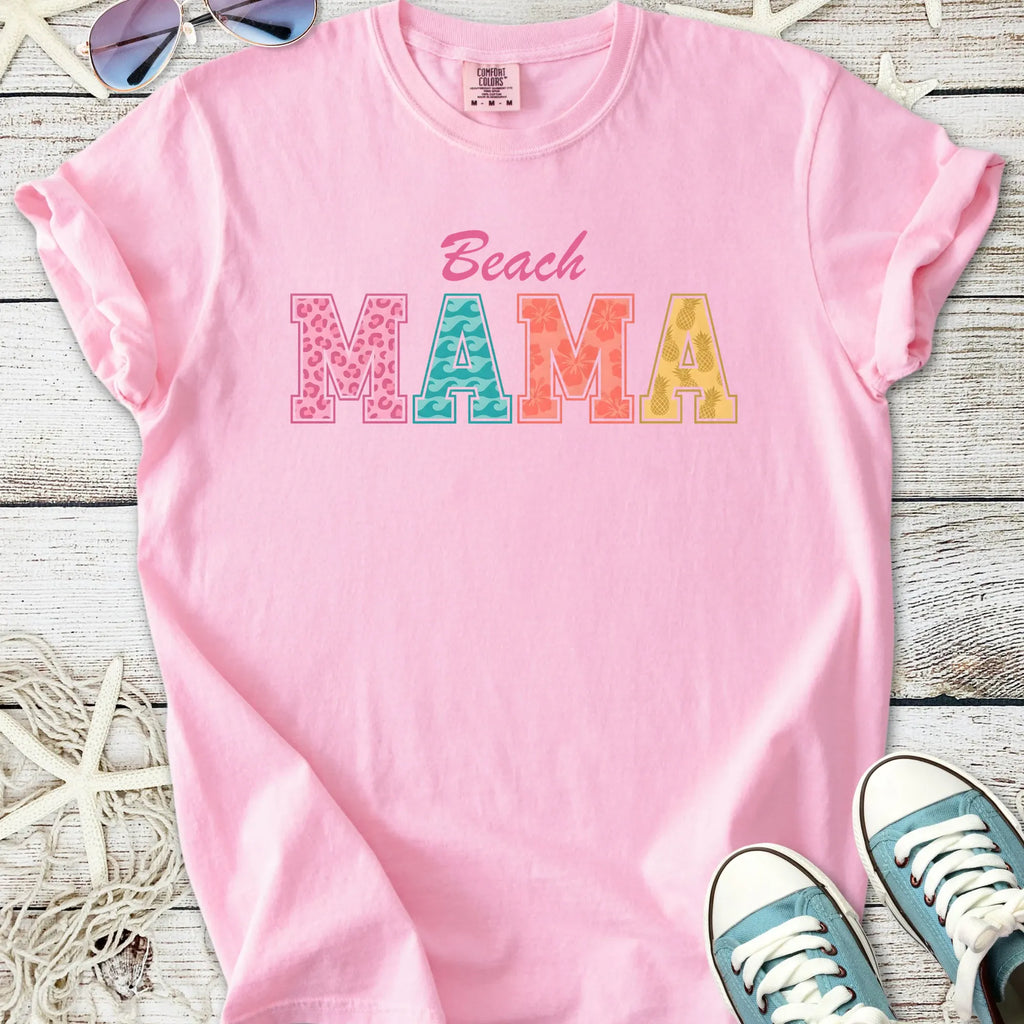 Pink cotton t-shirt with 'Beach MAMA' graphic in colorful letters, perfect for summer outings.